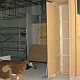 Custom built partition wall with door for stacking the sliding folding shutter into (please note this is a builder's shopfitter's item)